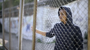 Young boy behind bars 